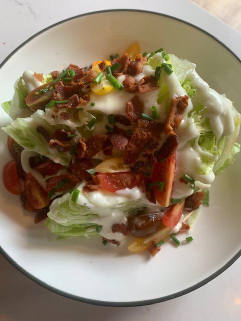 Wedge Salad · iceberg. blue cheese. bacon crumbles. tomato. chive.