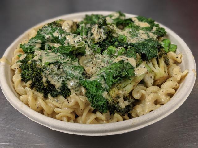 Mac + Greens Bowl · Our classic cashew mac + cheese topped with seasoned grilled kale, broccoli, and peas.