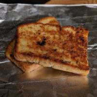 Side Garlic Bread · Our house made bread, grilled in garlic-herb oil.