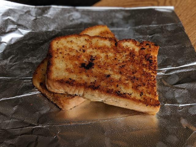 Side Garlic Bread · Our house made bread, grilled in garlic-herb oil.