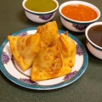 Vegetable Samosa · 2 turnovers filled with peas and potatoes served with tamarind chutney.