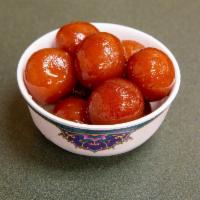 Gulab Jamun · 2 fried dough balls made with powdered milk and white flour and dipped in sugar syrup.