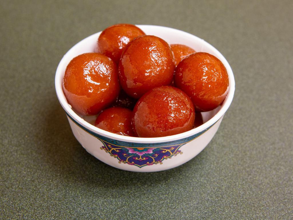 Gulab Jamun · 2 fried dough balls made with powdered milk and white flour and dipped in sugar syrup.