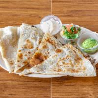 Meat Quesadilla · Choice of meat, sides of sour cream, guacamole and pico. Made on a 14