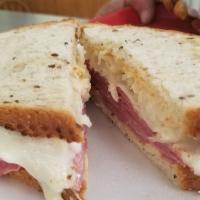 Reuben Sandwich · Hot corned beef, melted Swiss cheese served on deli rye with sauerkraut and thousand island ...