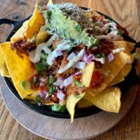BBQ'd Pulled Pork Nachos · Ranchero beans, nacho and colby jack cheese, mexicna crema, cilantro, scallions, red onions ...