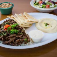 Shawarma Steak · Layered strips of marinated Angus beef, delicately spice and slow grilled. Served with rice,...
