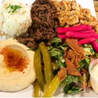 Shawarma Combo · Marinated sliced beef and chicken. Served with rice, hummus and pita bread.
