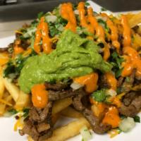 Asada Fries · Fries topped with cheese, asada beef, sour cream, guacamole, cilantro, onions & our famous s...