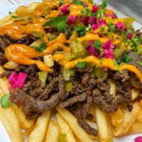 Shawarma Fries · Fries topped with beef or chicken shawarma, turnips, pickles, parsley, tomato & our famous s...
