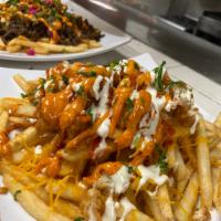 Buffalo chicken zinger fries · Fries topped with our crispy chicken tenders, cheese, tomato, ranch, buffalo & our famous sa...