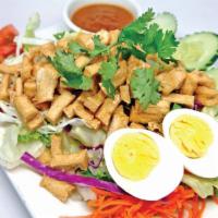 President's Salad · Iceberg lettuce with boiled egg, soybean tofu, cucumber, and tomato topped with homemade pea...
