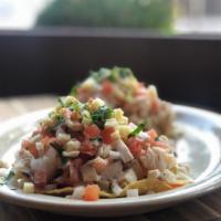 Ceviche Tostadas · Guacamole spread, lettuce, lime marinated white fish, shrimp, octopus and pico de gallo.