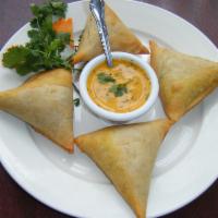 Chicken Samosas · Triangular puffed pastry, spiced with paach-foron. Stuffed with minced chicken, sweet corn, ...