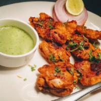 TANDOORI CHICKEN-4 PIECES · 4 pieces. Chicken leg and thigh, lightly marinated in spices and lemon juice, skewered to ba...