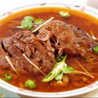 Nihari · Beef shank cooked in spices. Garnished with ginger, pepper, and cilantro.