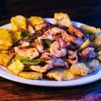 Fajitas Habaneras · Grilled Shrimp & Chicken served on
Tostones w/ Green Peppers & Onions