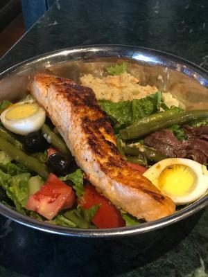 Salad Nicoise with Grilled Salmon · Romaine lettuce, string beans, tomatoes, Nicoise olives, hard-boiled egg, anchovies, and our house vinaigrette.