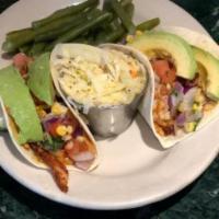 Fish Tacos · Topped with avocado, corn, and tomato salsa served with coleslaw and french fries.