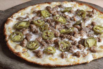Meat and Peppers Pizza · Olive oil, fresh shredded mozzarella, Italian sausage, beef meatballs and jalapenos.