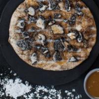 Dessert Pizza · Butter, cinnamon, icing, powdered sugar, caramel and Oreo cookie crumbles.