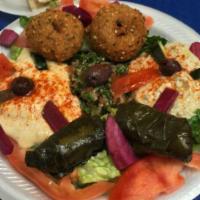 Sampler Plate · Falafel, dolmas, hummus, tabouleh, baba ghanouj served with tzaziki sauce.