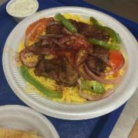 Lamb Kabob Plate · Marinated pieces of tender lamb, topped with chopped onions, green peppers, tomatoes and sea...