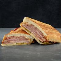 The Cuban Combo with Fries · Smoked virginia ham, mojo pork, boiled ham with pickles, Swiss, hellmanns mayo and yellow mu...