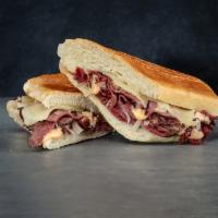 Reuben on Cuban Combo with Chips · Hot pastrami, sauerkraut, Swiss cheese and Russian dressing on real Cuban bread. Served with...