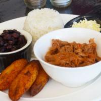 Pabellon · White rice, black beans, shredded meat, sweet plantains and white cheese.