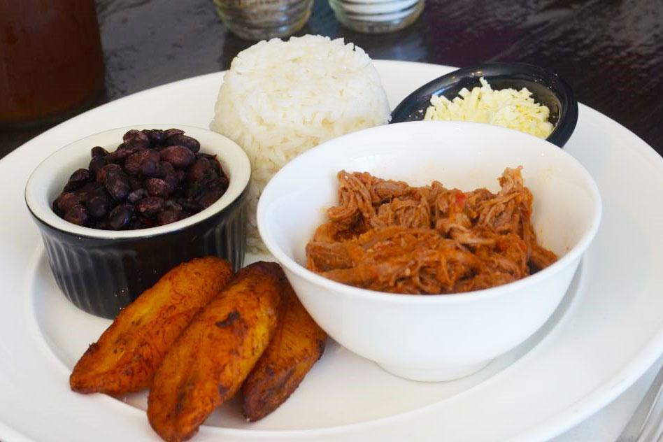 Pabellon · White rice, black beans, shredded meat, sweet plantains and white cheese.