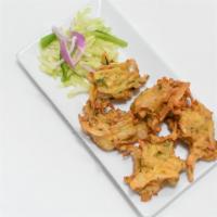 Vegetable Pakora · 5 pieces. Fresh vegetable fritters made with spinach, potatoes, onion, and cauliflower.