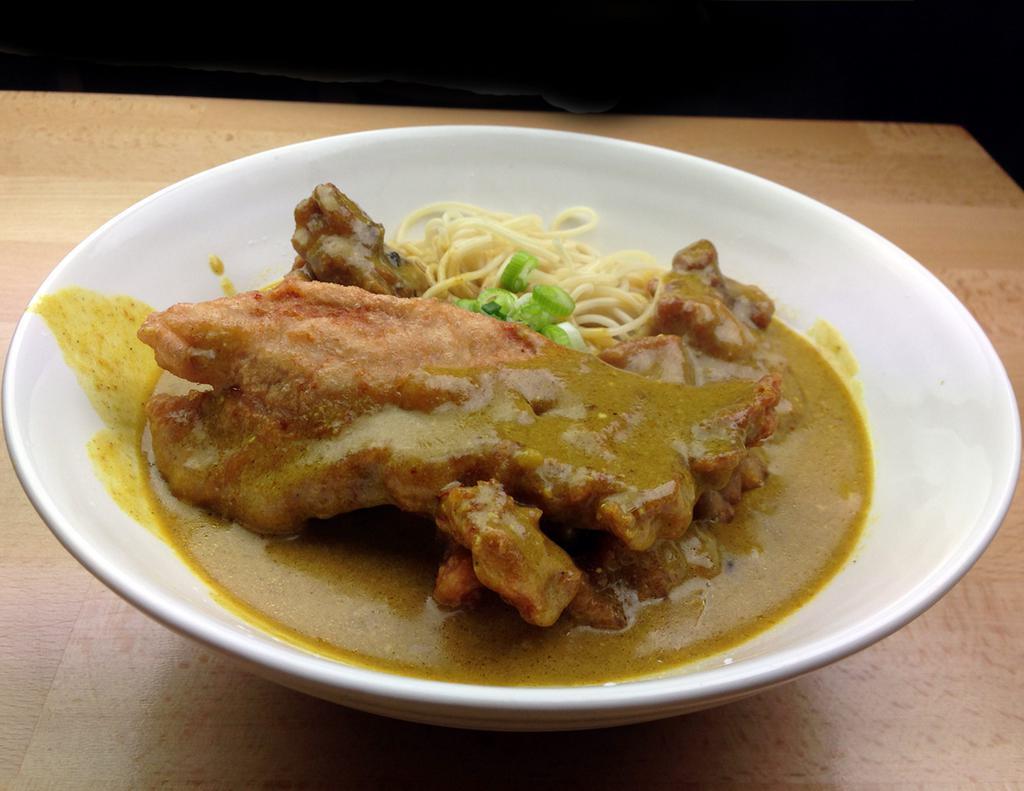 73. Curry Pork Chop Ramen 咖喱豬扒拉麵 · Marinated pork chop batter-coated deep tried on flavorful curry soup ramen noodle.