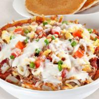 Carnitas Queso Skillet · Two scrambled eggs, pulled pork, bacon, sausage, tomatoes, onions, on a bed of seasoned hash...