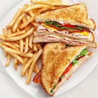Triple Decker Club Sandwich · Ham, smoked turkey breast, bacon, American and Swiss cheeses, lettuce, tomato and mayo on th...