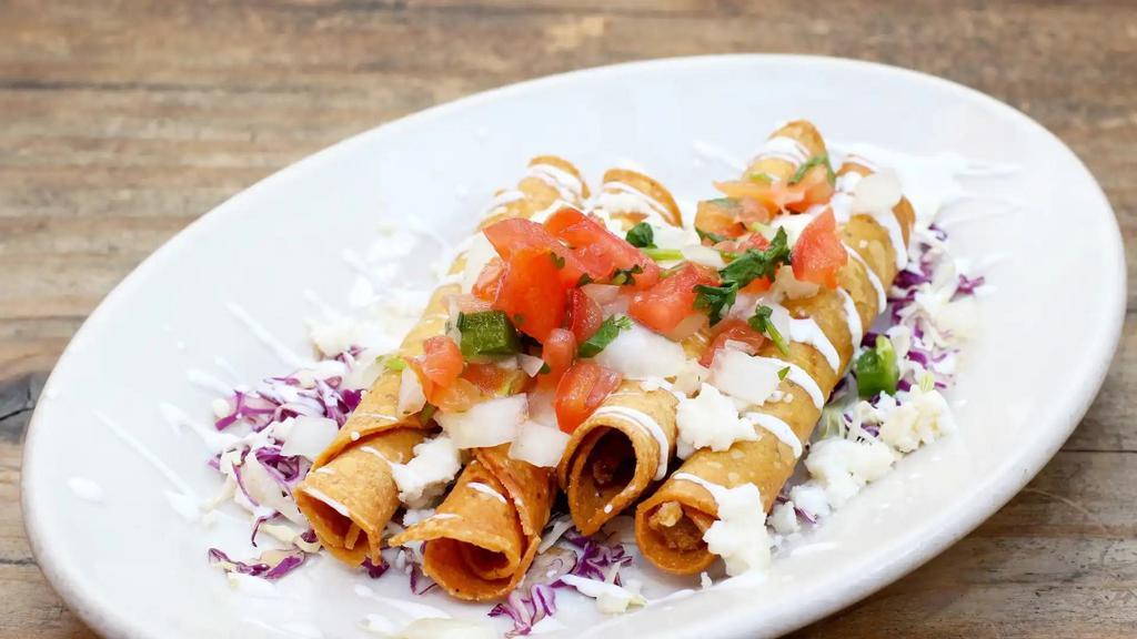Taquitos de Papa · Four crispy rolled tortillas filled with potatoes and cheese. Served with salsa fresca, sour cream, cheese, and cilantro.