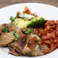 Carnitas  · Pork shoulder braised in pork fat served with avocado, salsa fresca and whole pinto beans.
