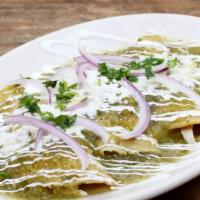 Enchiladas Verdes · Handmade corn tortillas dipped in a tomatillo and green chile sauce filled with roast chicke...