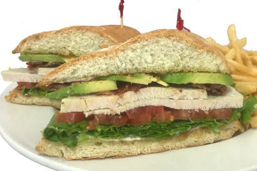 Ruby Club Sandwich Combo · Hand-carved turkey breast with thick-cut bacon, crisp lettuce, tomato, mayo and sliced avocado on a deliciously soft ruby roll. Served with fries.