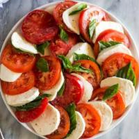 Mozzarella Caprese · Slices of fresh mozzarella and tomatoes, topped with basil, homemade balsamic vinaigrette an...