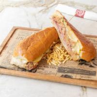 Cubano Sandwich · A Cuban classic served with ham, roasted pork, swiss cheese, pickles and mustard. Served in ...