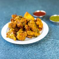 Mixed Vegetable Pakoras · Vegetables with chickpea batter, deep fried. Served with mint sauce and tamarind sauce. Vega...
