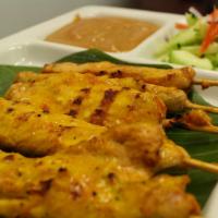 Satay · Grilled marinated chicken on skewers served with peanut sauce and cucumber salad.