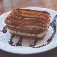 Tiramisu · An Italian dessert made with mascarpone, espresso-soaked ladyfingers, whipped cream and a da...