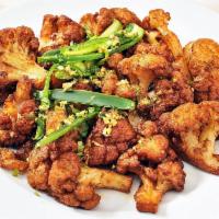 Gobi Manchurian Dry · Batter-fried cauliflower tossed in a spicy blend of Indo-Chinese spices.
