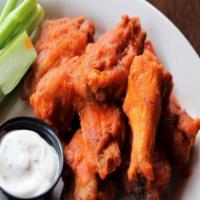 Buffalo Style Wings · Some like it hot. Signature chicken wings tossed in our house spicy buffalo sauce. Served wi...
