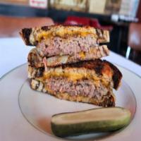 Classic Patty Melt Burger · Smashed and grilled 1/2 lb USDA choice beef patty with cheddar cheese and sautéed onions on ...