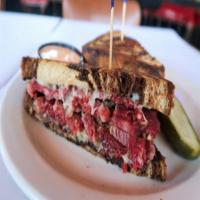 Famous Corned Beef Sandwich · Our pretty in pink, savory corned beef with Swiss cheese, sauerkraut and thousand island dre...