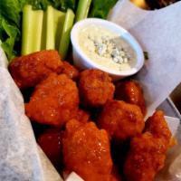 Boneless Chicken Bites · Breaded all-white chicken tossed in our house-made Buffalo sauce. Served with celery and you...