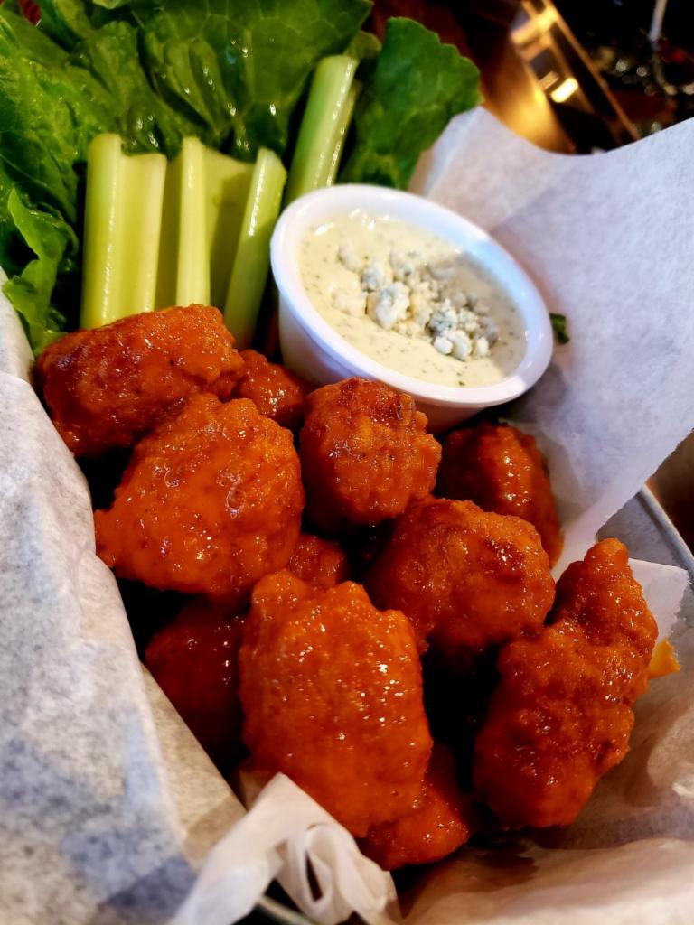 Boneless Chicken Bites · Breaded all-white chicken tossed in our house-made Buffalo sauce. Served with celery and your choice of buttermilk ranch or blue cheese dressing.